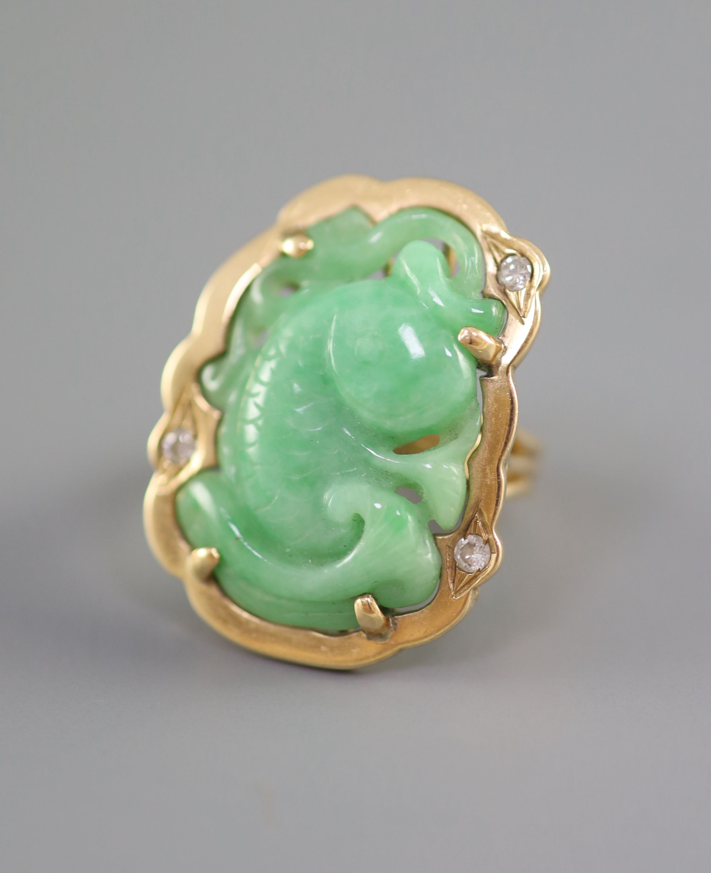 Two Chinese jadeite and gilt metal clips, first half 20th century and a yellow metal jadeite ‘fish’ ring, late 20th century, Clips 4.5 and 5cm